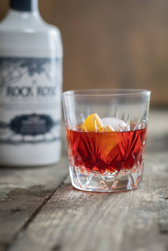 Bottle of Rock Rose Navy Strength and Navy Strength Negroni cocktail garnished with lemon peel