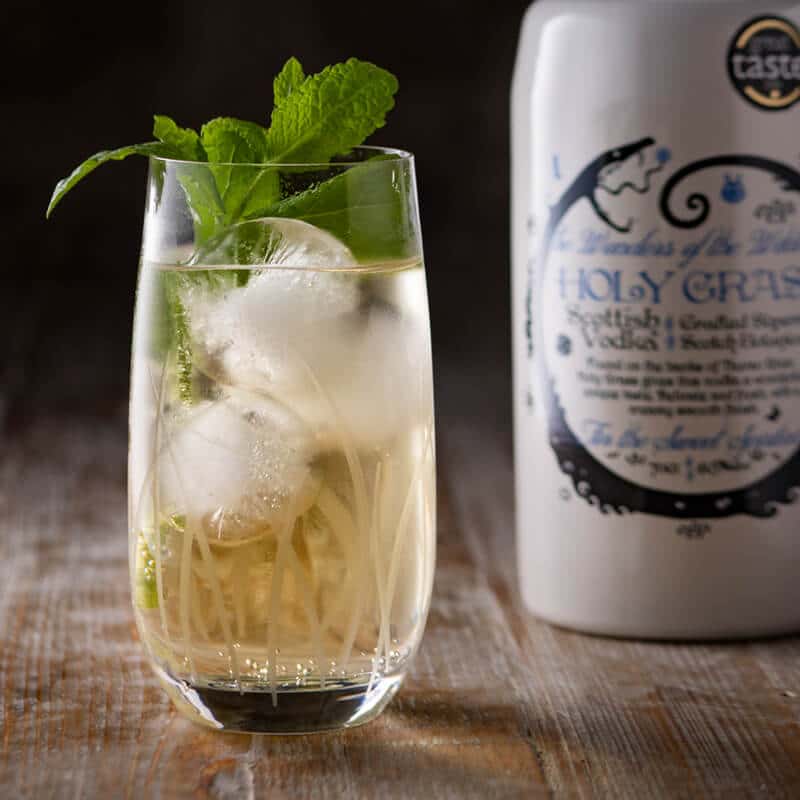 Cocktail served in a tall Holy Grass Vodka branded Glass