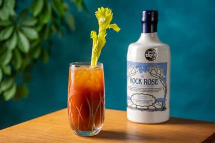 Bottle of Rock Rose Gin and Rose Red Snapper cocktail served in a tall glass