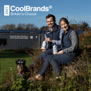 Featured image for Britain's Choice CoolBrands 2021-22 award with Claire, Martin and Mr Mackintosh the dog in front of the Distillery
