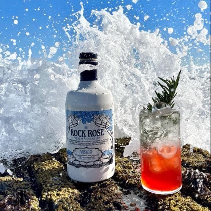 Bottle of Rock Rose Gin with Mo Chridhe My Hear cocktail - by Ross Lawrie - served in a long glass and garnished with a sprig of thyme