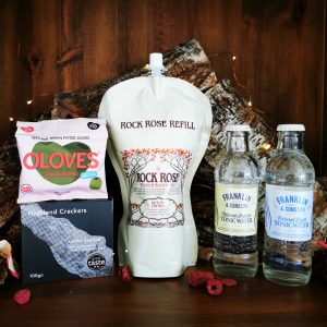 Content of the Refill Rewards Club box for November 2021 including Rock Rose Gin pouch, tonic waters, pack of olive and highland crackers
