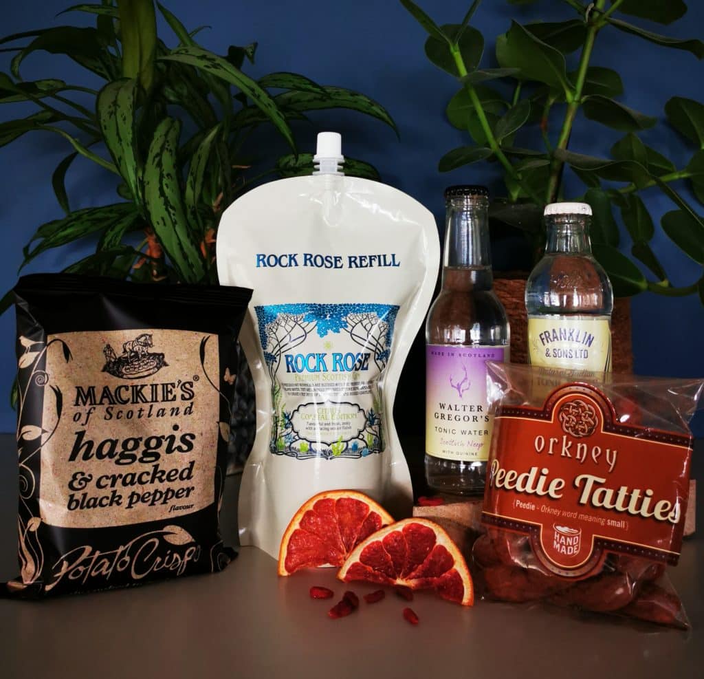 Content of the Refill Rewards Club box for January 2022 including Rock Rose Gin pouch with haggis et black pepper crisps, tonic waters and peedie tatties