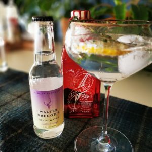 Bottle of Lassies Toast, Tonic water and cocktail served in a coupe glass