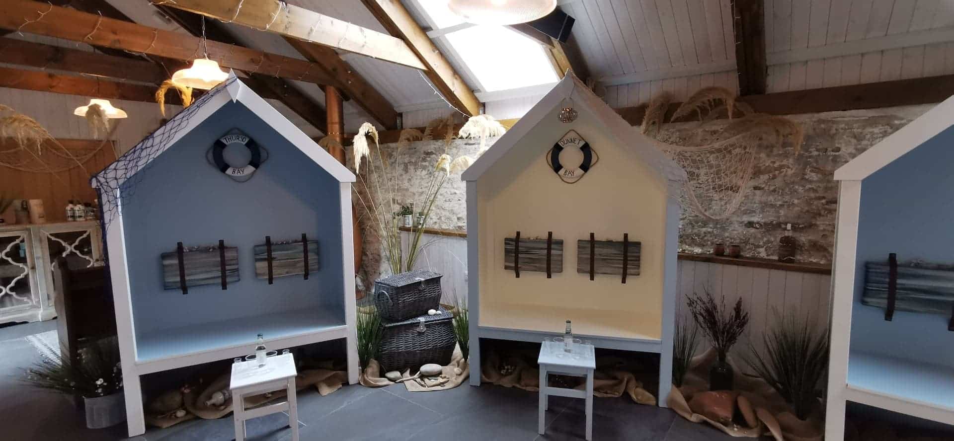 Three wooden indoor boat sheds in the tasting room