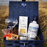 Picture of our "All Things Rock Rose" hamper including a bottle of Rock Rose Gin Original Edition, a branded glass, a candle, and a Chocolate Lollipup, Gin & Toni jellies