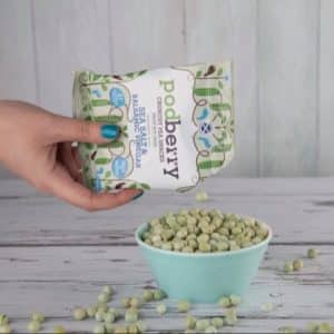Hand serving a pack of Podberry sea salt and balsamic vinegar crunchy peas snack
