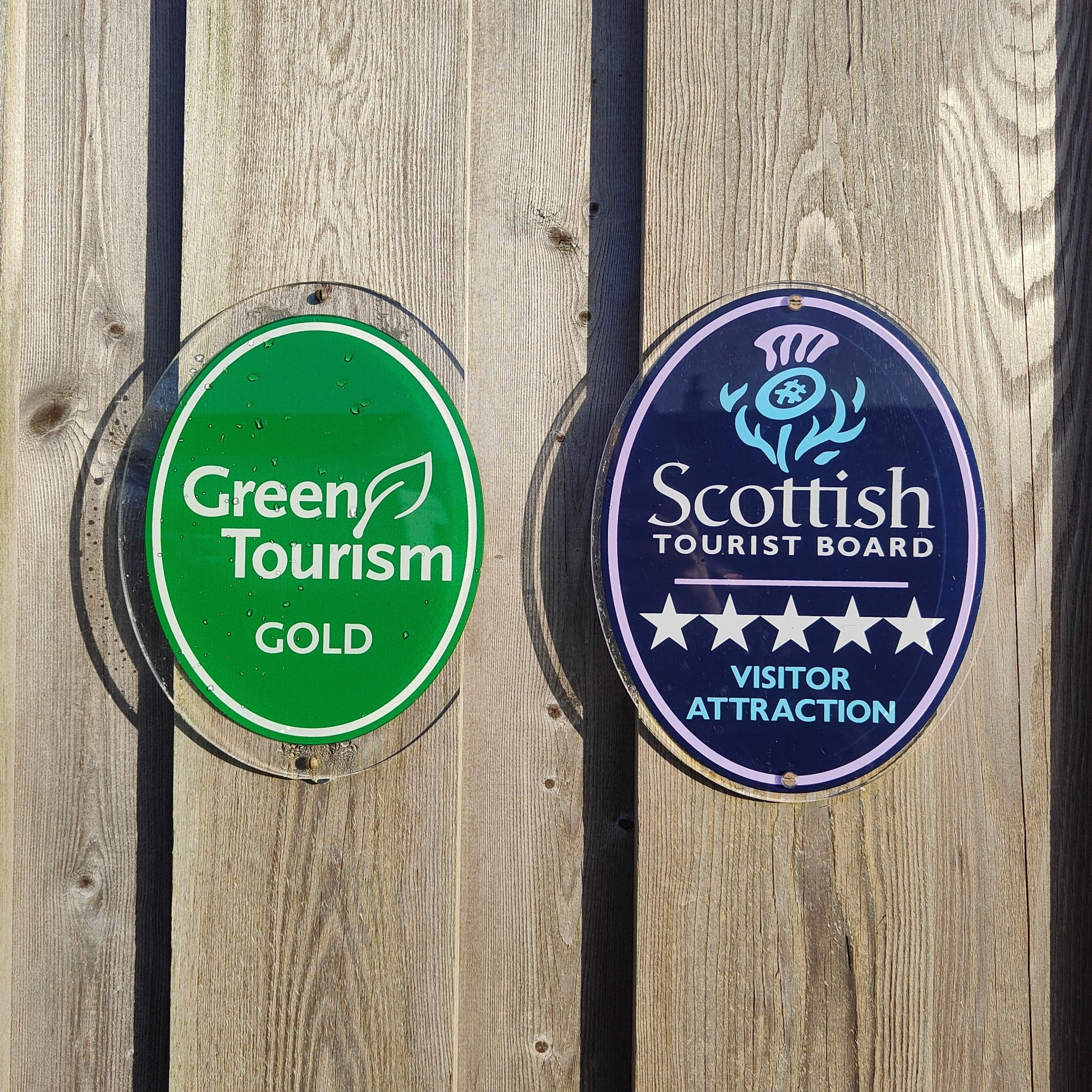 Picture of Green Tourism and Scottish Tourist Board awards on wood panel wall
