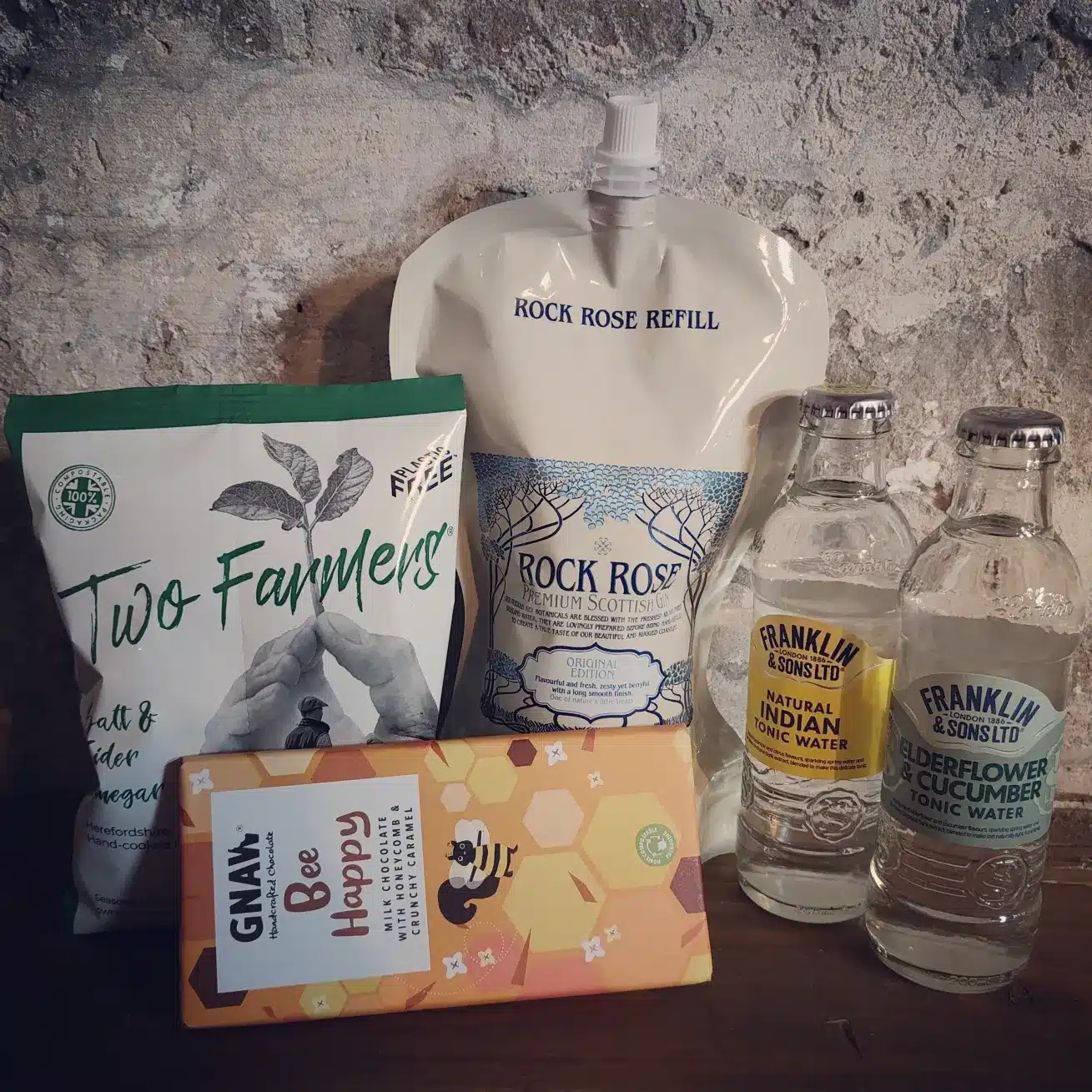 Content of the Refill Rewards Club box for February 2023 including Rock Rose Gin pouch, 2 tonic waters, sea salt and vinegar crisps and
