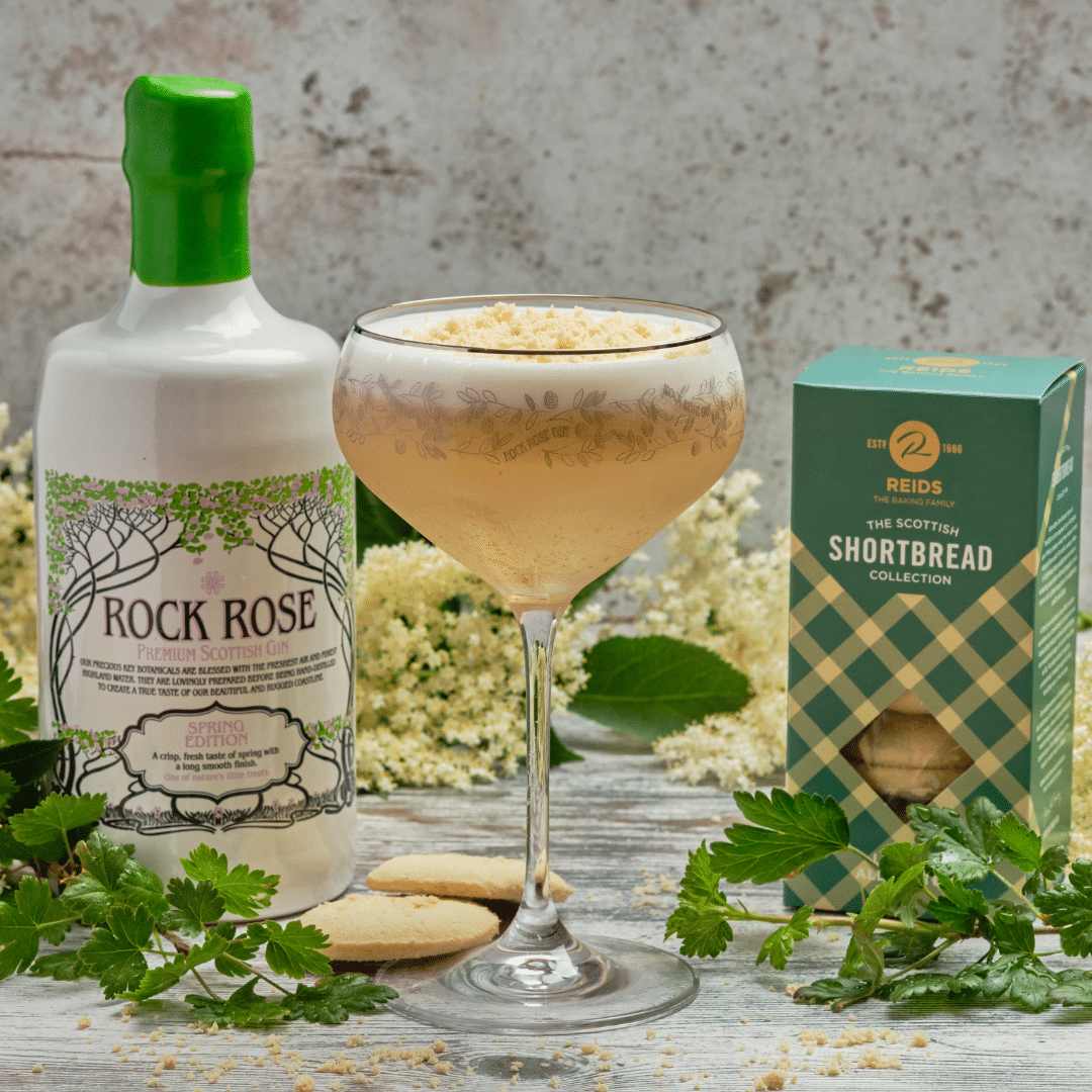 Bottle of Rock Rose Gin Spring edition with Gooseberry Spring Fool cocktail served in a coupe glass and garnished with Shortbread biscuits