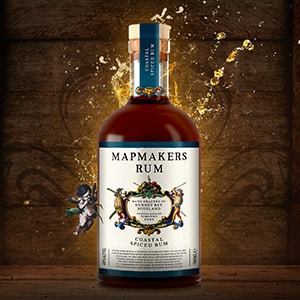 Bottle of Coastal Spiced Mapmaker's rum with image of an angel on a wooden background with the slogan "Rum worth finding"