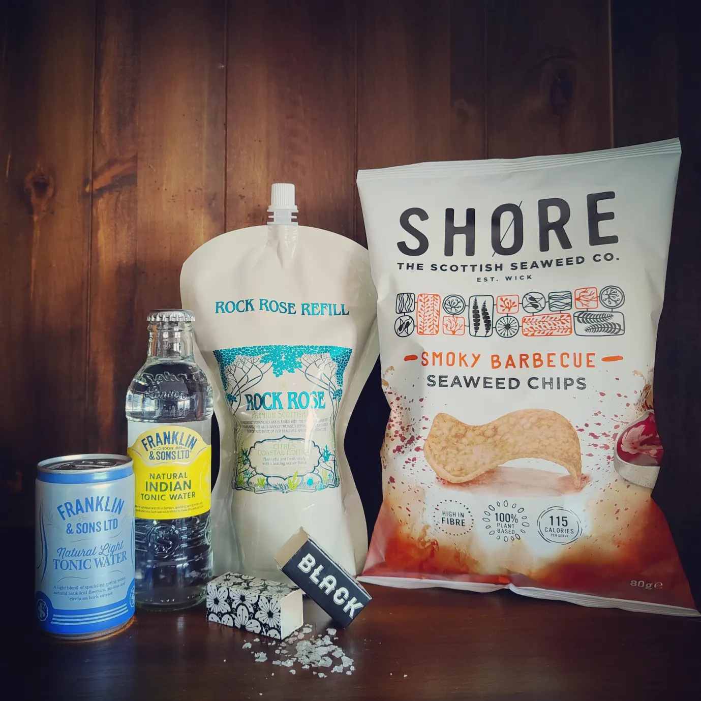 Content of the Refill Rewards Club box for April 2023 including Rock Rose Citrus Coastal edition, Shore seaweed crisps, 2 tonic water and Scottish sea salt flakes